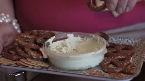Hand dipping pretzels Stock Footage 82539006