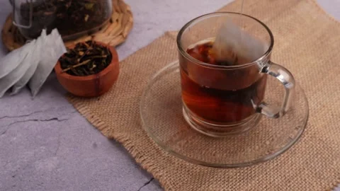 Hand dipping the tea bag repeatedly Stock Footage 274244080