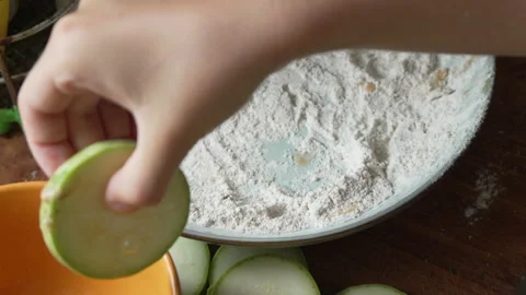 Hand Dipping Zucchini Slice in Flour for Frying Stock Footage 311641150