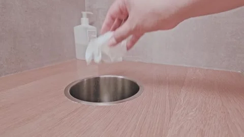 Hand Discarding Paper Towel Into Round Waste Bin Stock Footage 345717292