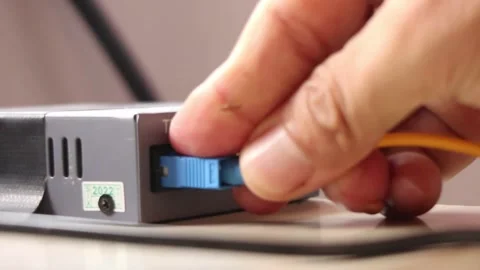 Hand disconnecting the internet network by unplugging the computer network cable Stock Footage 291595539