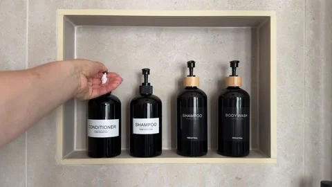 Hand dispensing conditioner from a refillable pump bottle Stock Footage 343679141