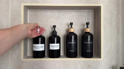 Hand dispensing conditioner from a refillable pump bottle Stock Footage 343679142