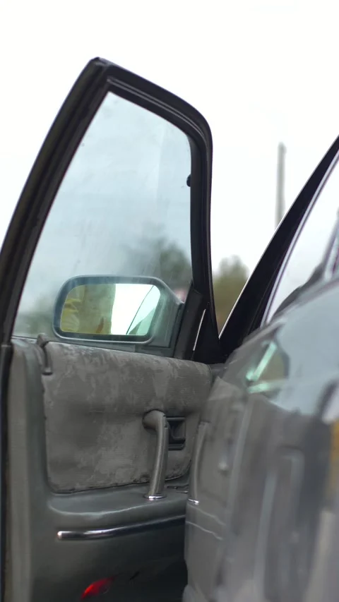 A hand in disposable gloves opens the car door and closes the door. pandemic Stock Footage 317162566