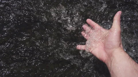 A hand dives into a stream of water. Point of view. Stock Footage 132244552