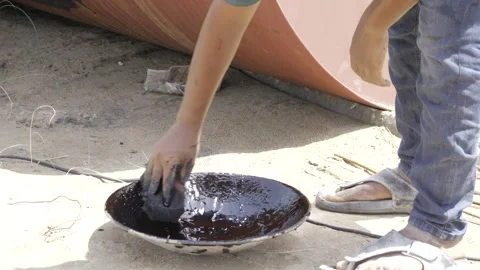 Hand Diving into Deep Black Liquid in Outdoor Setting Stock Footage 314468087