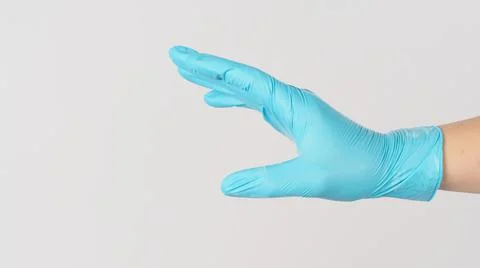 Hand do touching gesture and wear blue medical glove on white background. Stock Photos