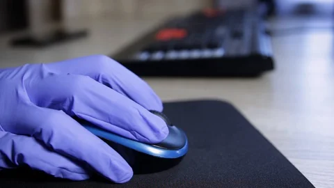 Hand of a doctor in protective gloves using mouse. Health and medicine concept Stock Footage 129662193