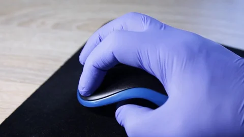 Hand of a doctor in protective gloves using mouse. Health and medicine concep Stock Footage 129662225