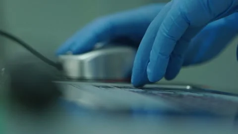 Hand of a doctor in protective gloves using mouse. Health and medicine concept Stock-Footage 153475065