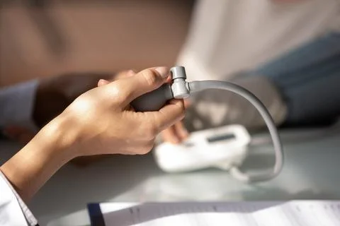 Hand of doctor using sphygmomanometer for checking blood pressure 写真素材