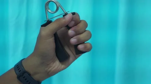 Hand doing exercises with hand grip Stock Footage 328645905