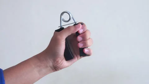 Hand doing exercises with hand grip Stock Footage 328986799