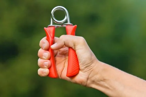 Hand doing exercises with hand grip Stock Photos