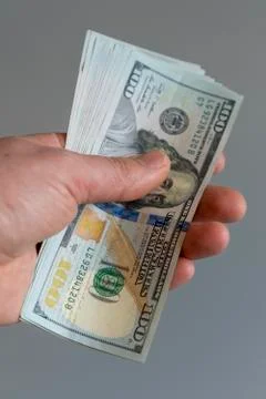 Hand with dollars on a gray background. dollars money finance currency in han Stock Photos