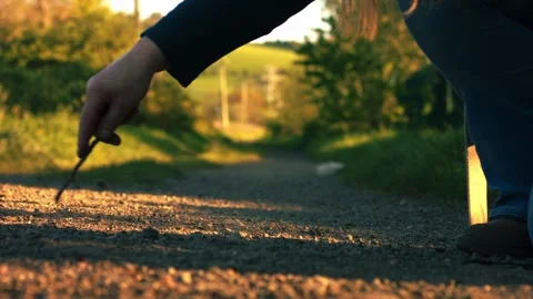 Hand doodling with stick on dusty path 스톡 동영상 333527526