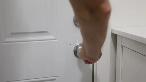 Hand with door handle and lock Stock Footage 310859535