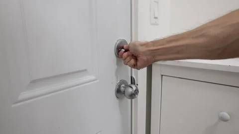 Hand with door handle and lock Stock Footage 310859537