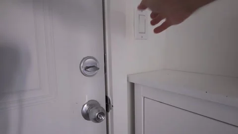 Hand with door handle and lock turn on light Stock Footage 310859544