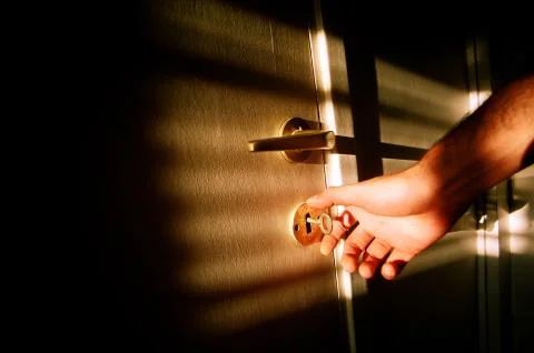 Hand on door key Stock Photos