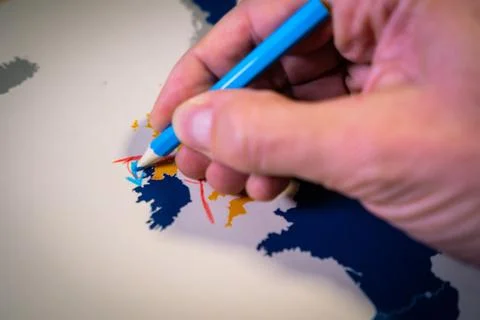 Hand drawing a blue arrow between the UK and Northern Ireland, Backstop and Stock Photos