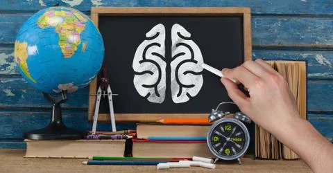 Hand drawing brain on blackboard with study objects Stock Photos