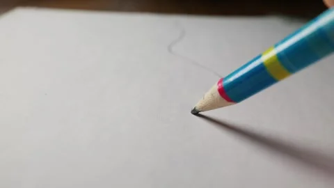 Hand Drawing Curved Graphite Line with Colorful Pencil on White Paper Stock Footage 339365817