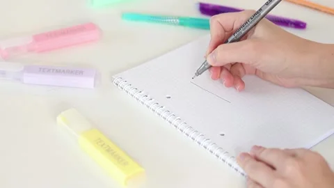 Hand drawing exclamation mark in notebook on white table Stock Footage 331801608