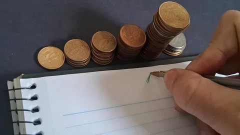Hand drawing growth chart near rising coin stacks Stock Footage 345448483