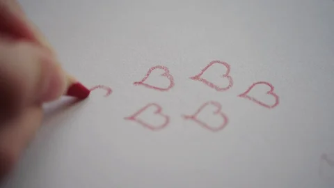 Hand drawing heart contours by red pencil on Valentine's day Stock Footage 101290171