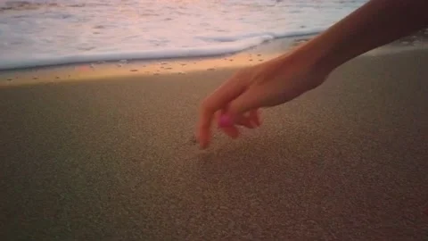 Hand Drawing Heart Shape On Sand Of The Beach. Stock Footage 137970546