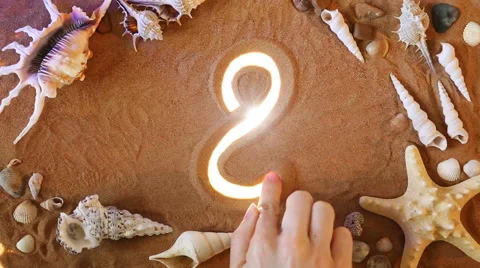 Hand drawing Number Eight 8 symbol in the sand. Beach background. Top view Video stock 61586890