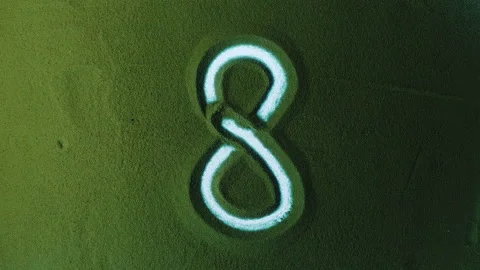 Hand drawing Number Eight 8 Symbol in the Green Sand. Stock Footage 209935597