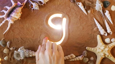 Hand drawing Number Nine 9 symbol in the sand. Beach background. Top view Stock Footage 61586872
