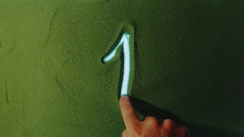 Hand drawing Number One 1 Symbol in the Green Sand. Stock Footage 209931558