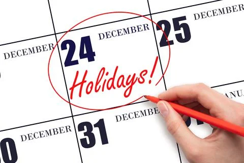 Hand drawing a red circle and writing the text Holidays on the calendar date  Stock Photos