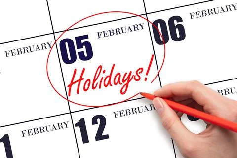 Hand drawing a red circle and writing the text Holidays on the calendar date  Stock Photos