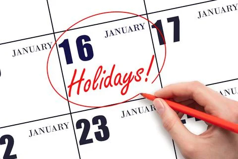 Hand drawing a red circle and writing the text Holidays on the calendar date  Stock Photos