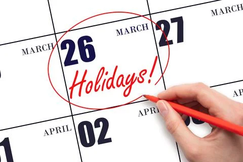 Hand drawing a red circle and writing the text Holidays on the calendar date  Stock Photos