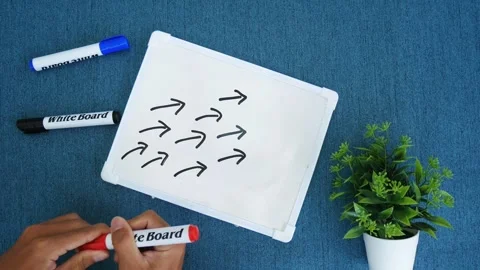Hand drawing red curve arrow leader with many small followers on blackboard. Stock Footage 264304220