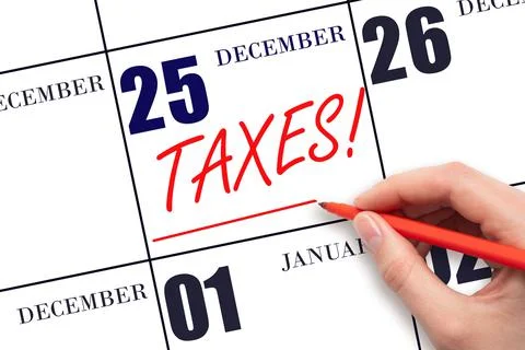 Hand drawing red line and writing the text Taxes on calendar date December 25 Stock Photos