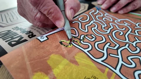 Hand Drawing Through Colourful Maze Puzzle With Pen On Activity Book Page Stock Footage 339031947