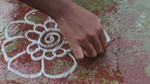 Hand Drawing Traditional Kolam Pattern on Floor Stock Footage 324867638