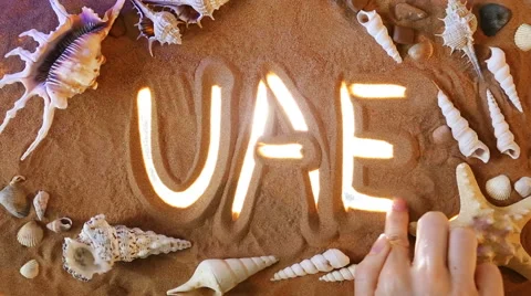 Hand drawing UAE symbol in the sand. Beach background. Top view Video stock 61587078
