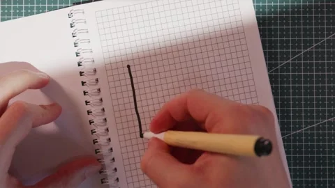 Hand drawing upward growth chart diagram in paper notebook Stock Footage 340139182