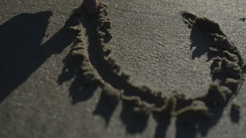 Hand Drawing in Wet Sand Stock Footage 208747691