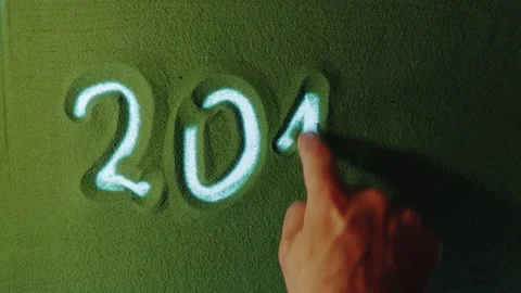 Hand drawing Year Number 2014 Symbol in the Green Sand. Video stock 209949539