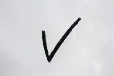 Hand drawn black check mark on white paper Stock Photos