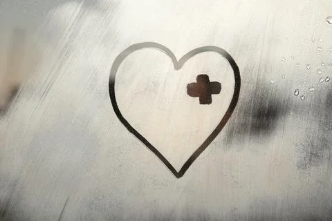 Hand drawn doodle with patch covering the wound painted on window flooded wit Stock Photos