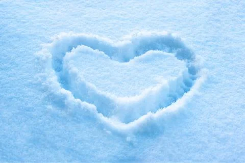 Hand drawn heart shape in the fresh snow, romantic symbol, Saint Valentines d Stock Photos